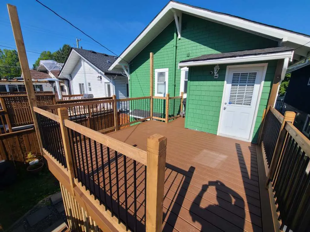 Garden cabin and deck with black railings